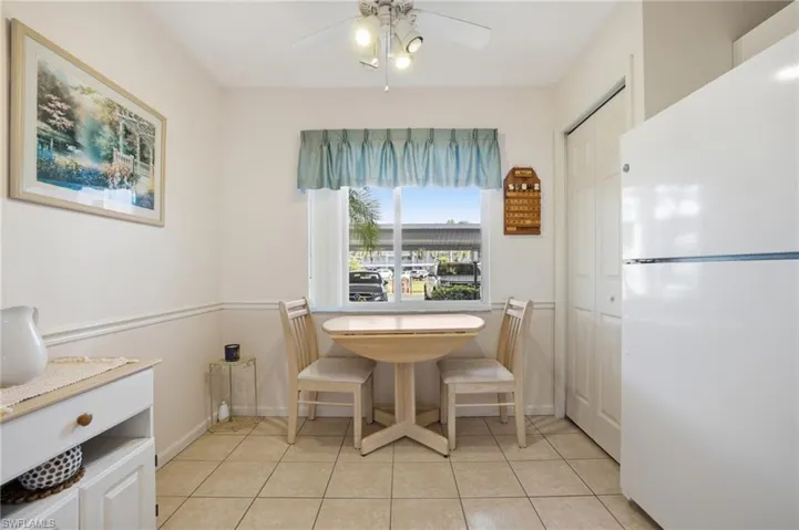 Dining room featuring light tile patterned floors and ceiling fan