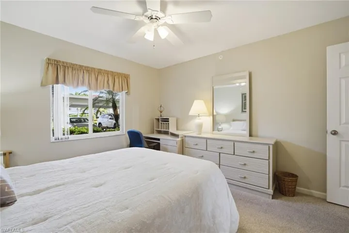 Bedroom featuring light carpet and a ceiling fan