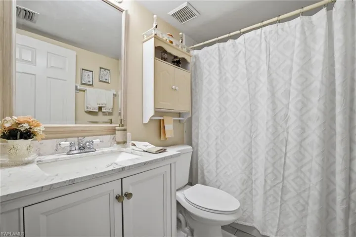 Full bathroom featuring a shower with shower curtain and vanity
