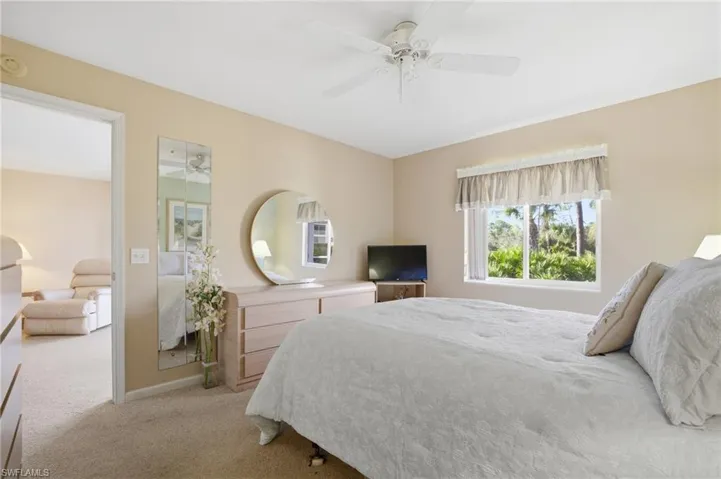 Carpeted bedroom featuring baseboards and a ceiling fan