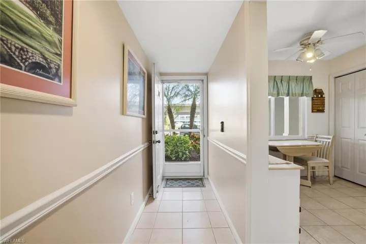 Entryway featuring tile patterned floors and a ceiling fan