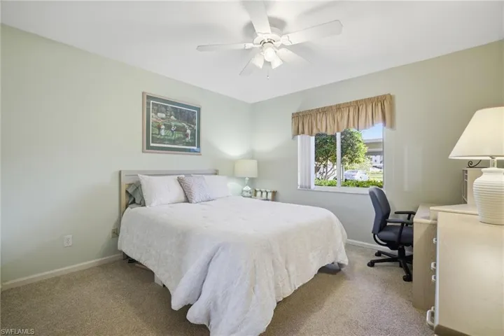 Bedroom featuring a ceiling fan, carpet floors, and an office area
