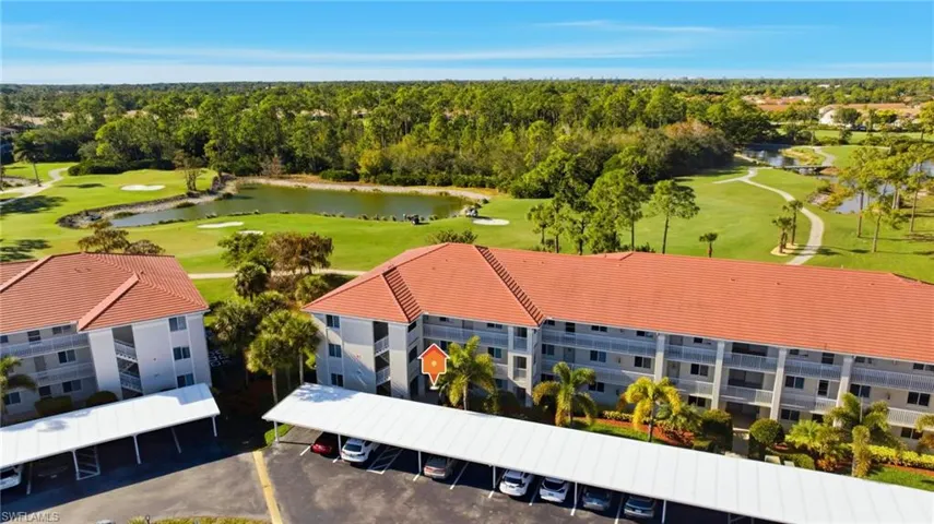 Drone / aerial view of a golf club and a nearby body of water