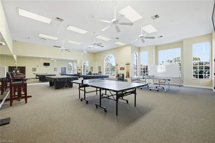 Recreation room with pool table, a skylight, and a ceiling fan