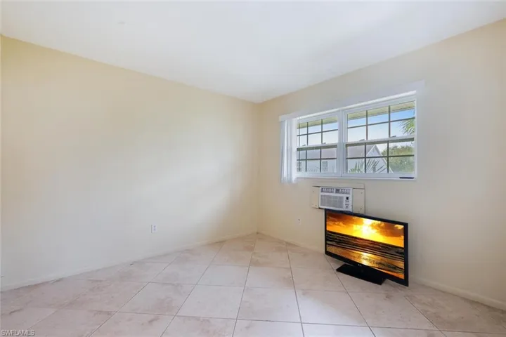 Unfurnished room with baseboards and light tile patterned floors
