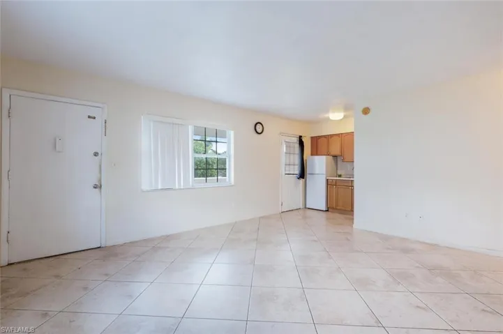 Unfurnished living room with light tile patterned floors