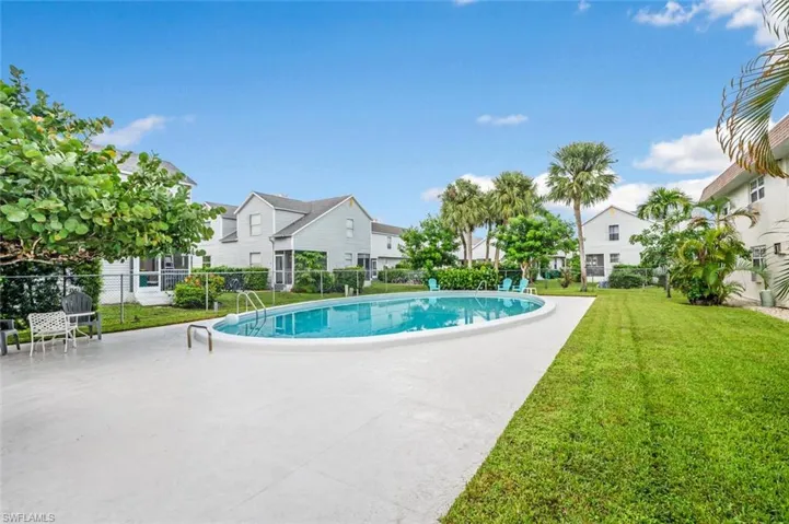 Community pool with a patio