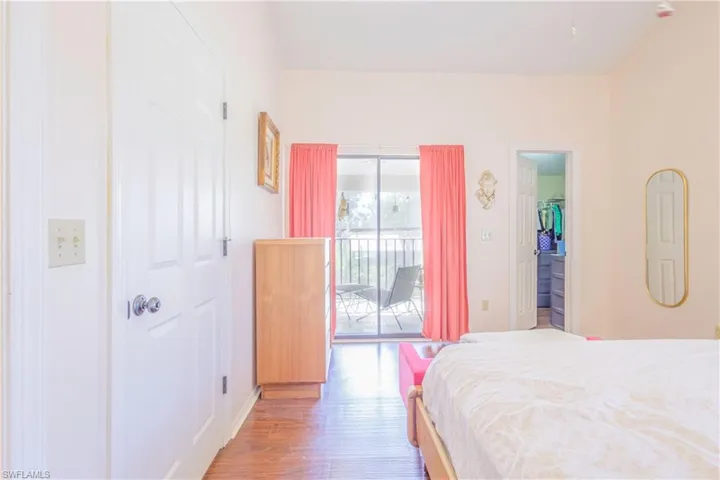 Primary en-suite bedroom with balcony and vaulted ceiling. (Unfurnished)