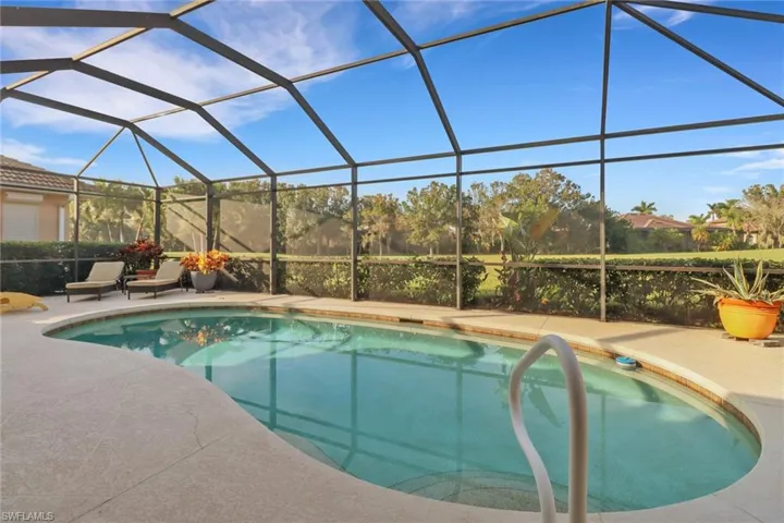 View of pool featuring a patio area and screened lanai