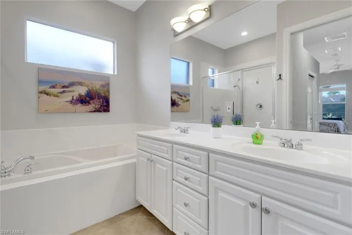 Bathroom with vanity, plus walk in shower, and tile patterned flooring