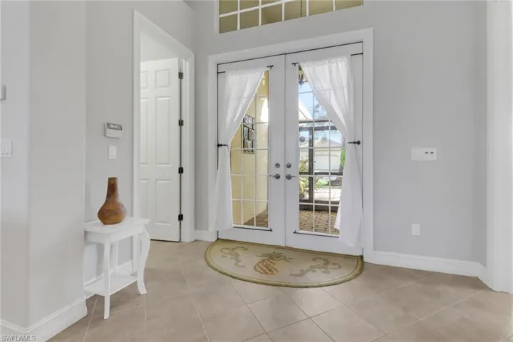Entryway with french doors and light tile patterned flooring