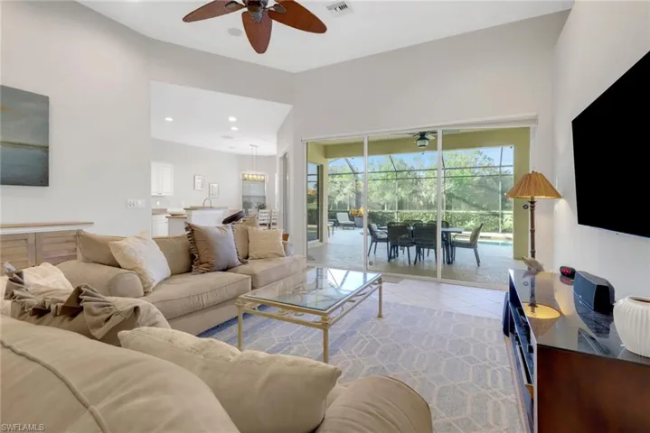 Tiled living room featuring ceiling fan