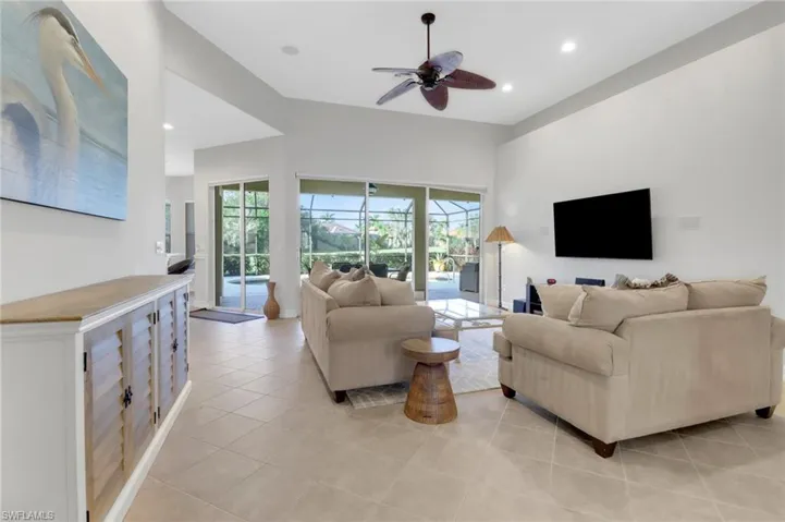 Tiled living room featuring ceiling fan