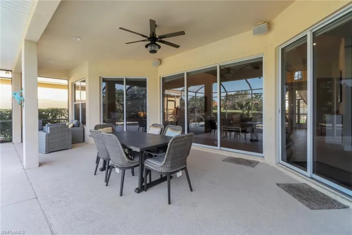 Pool area featuring ceiling fan and an outdoor hangout area