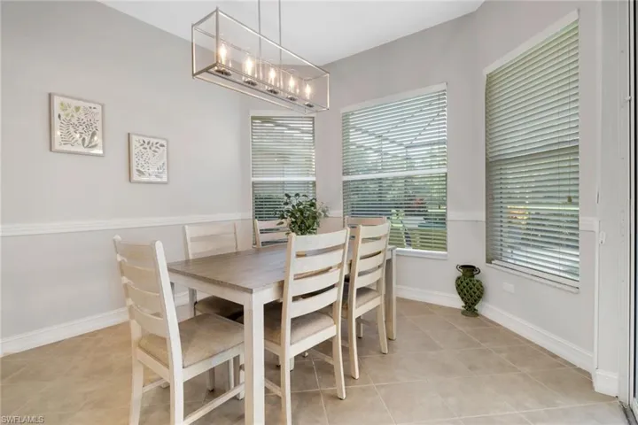 Tiled dining room featuring a chandelier