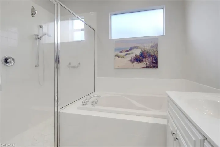 Bathroom featuring vanity and plus walk in shower