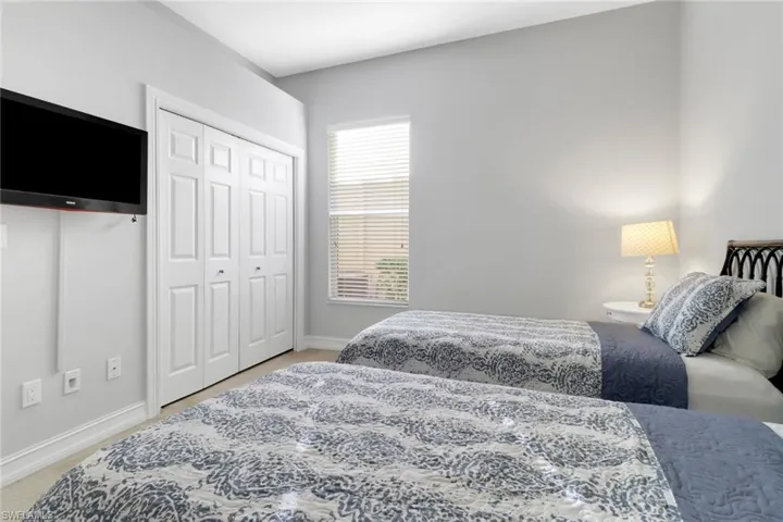 Carpeted bedroom with a closet