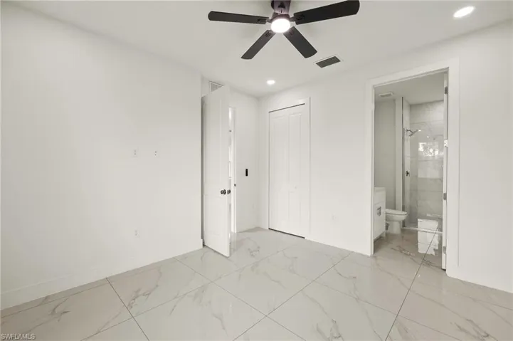 Unfurnished bedroom with light marble finish floors, baseboards, recessed lighting, and a closet