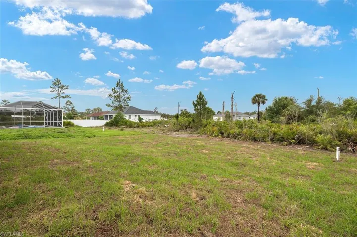 View of grassy yard with a lanai