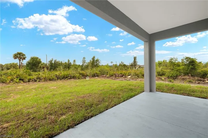 View of green lawn with a patio