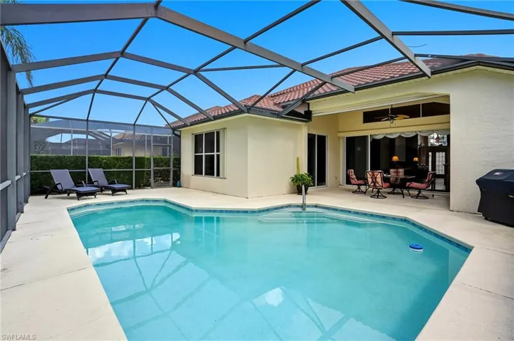 Swimming pool featuring a covered lanai, and area for grilling