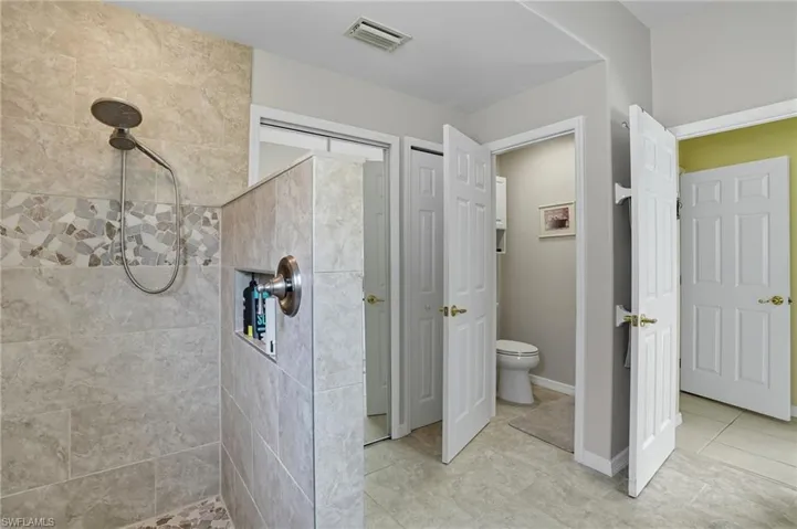 Bathroom featuring a stall shower and tile patterned floors