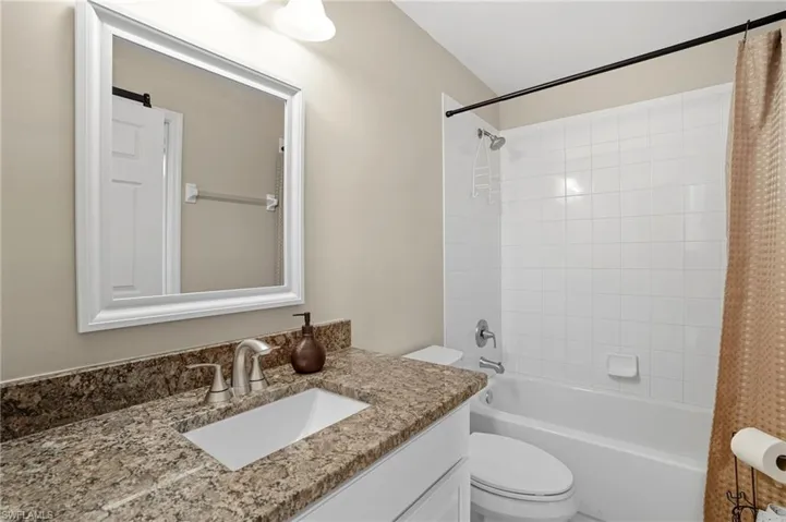 Full bath featuring shower / tub combo and vanity