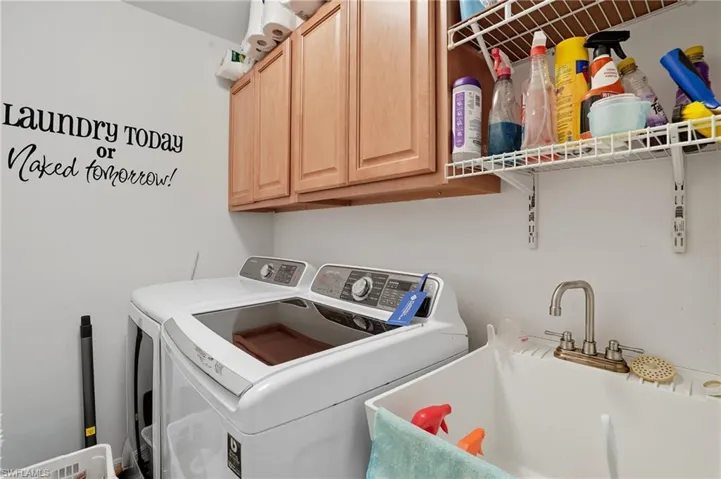 Main level; in residence Laundry area with cabinet space and washing machine and dryer