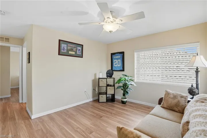 Loft sitting room featuring light wood-type flooring and ceiling fan
