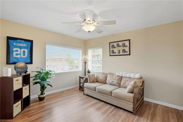 Loft sitting room with light wood-type flooring and ceiling fan