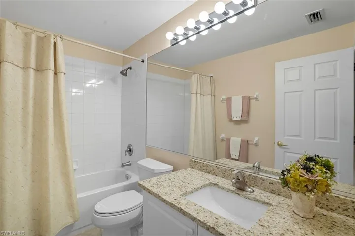 Full bathroom featuring shower / tub combo and vanity