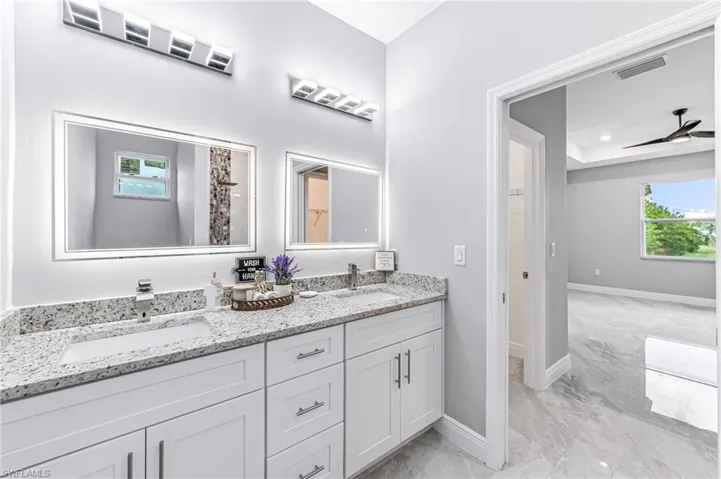Bathroom featuring ceiling fan and vanity