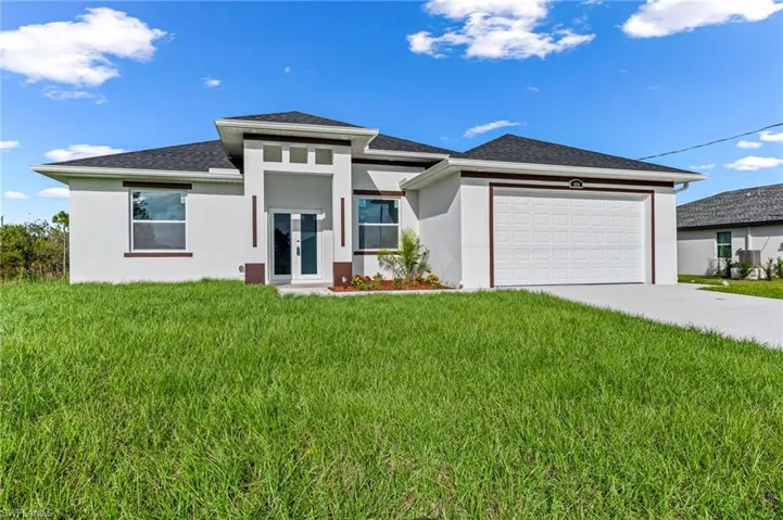 Prairie-style home with a front yard and a garage
