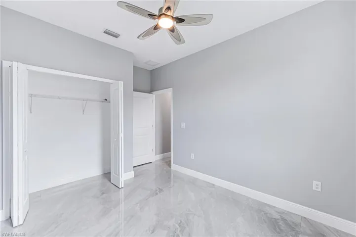 Unfurnished bedroom featuring a closet and ceiling fan
