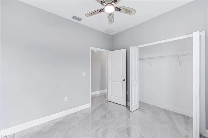 Unfurnished bedroom with a closet and ceiling fan