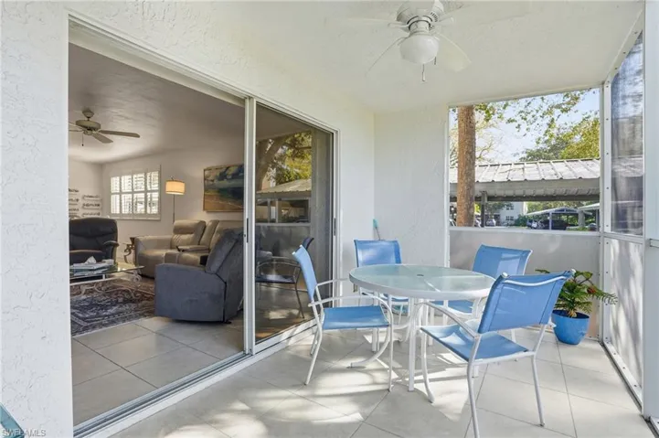 Sunroom with a ceiling fan, outdoor dining area, and a patio area