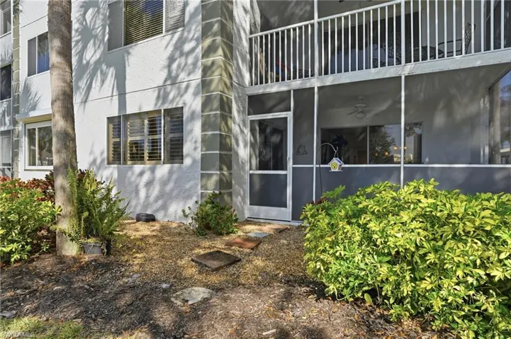 Entrance to property featuring stucco siding and a sunroom