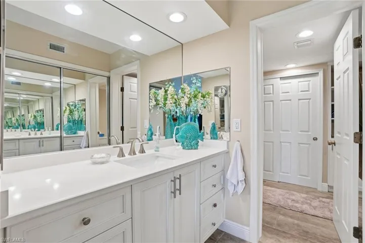 Full bathroom with vanity and recessed lighting