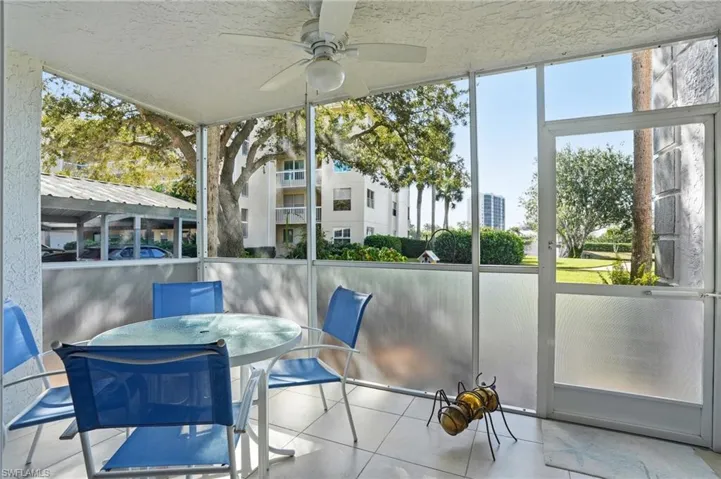Sunroom featuring outdoor dining area and ceiling fan