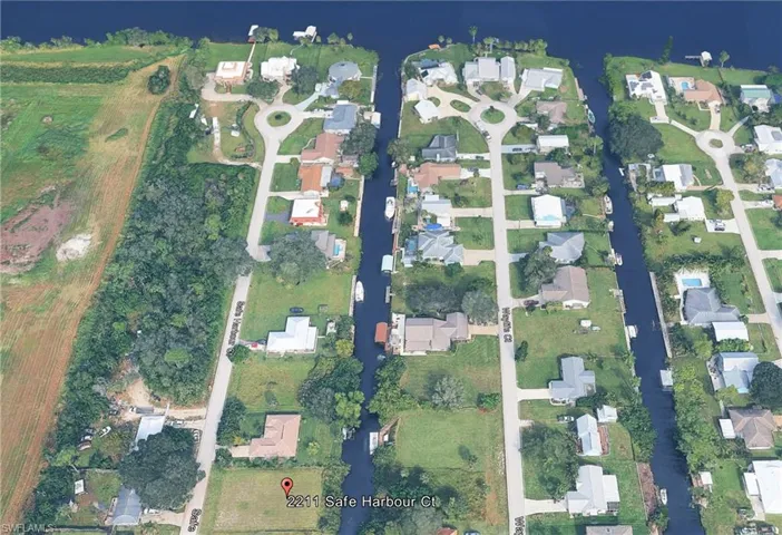 Aerial view of property's location with nearby suburban area