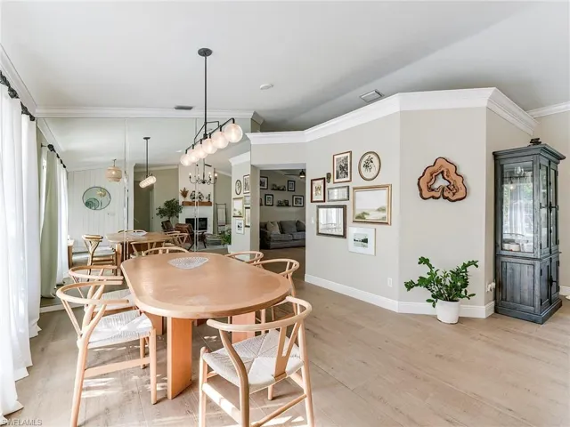 Dining room featuring crown molding and light wood-style floors