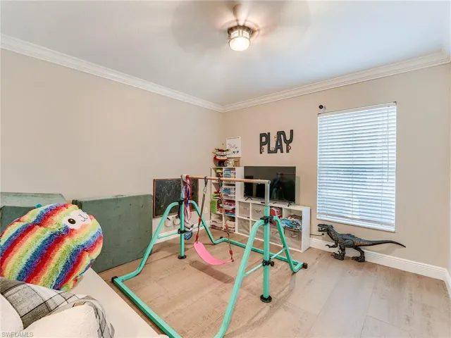 Game room 4 with crown molding, wood finished floors, and a ceiling fan
