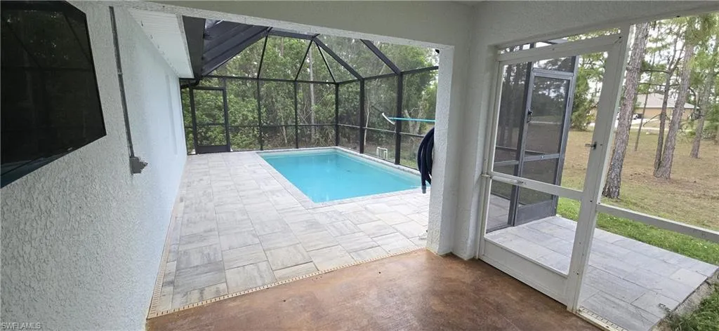 Outdoor pool featuring a patio area and a lanai
