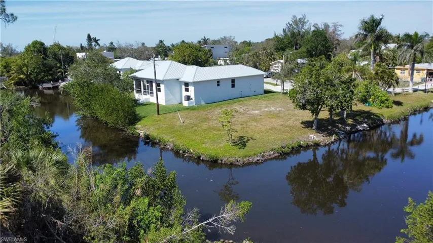 Birds eye view of property with a water view