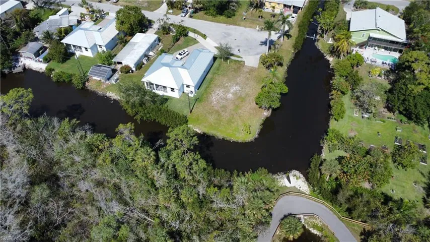 Birds eye view of property with a water view and a residential view