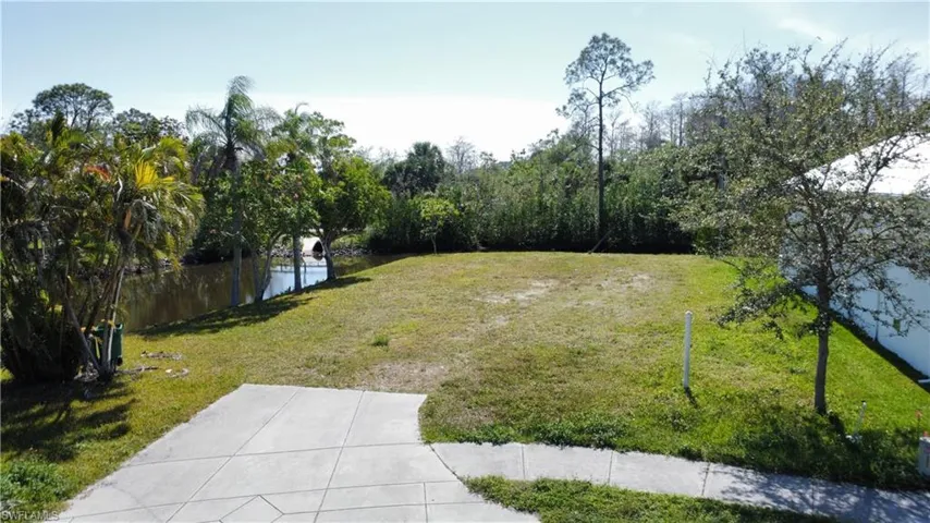 View of yard with a water view and fence