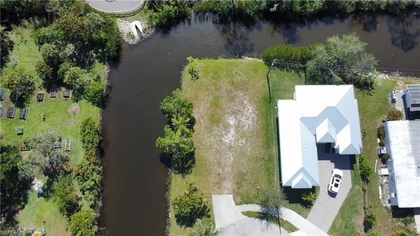Birds eye view of property with a water view