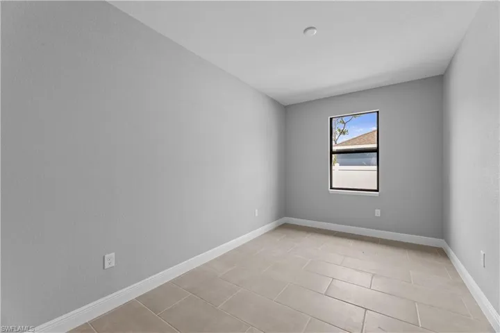 Spare room with light tile flooring