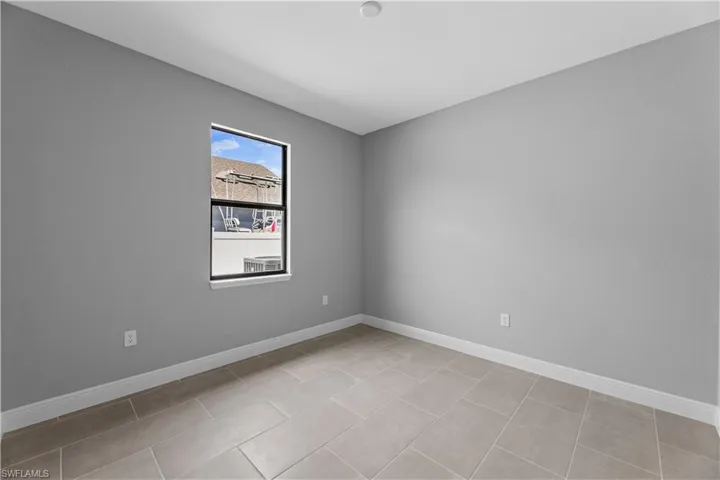 Empty room with light tile flooring