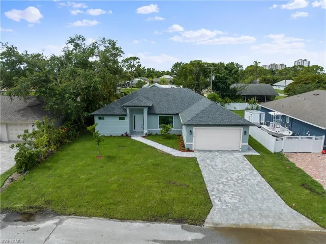 View of front of house with a garage and a front yard